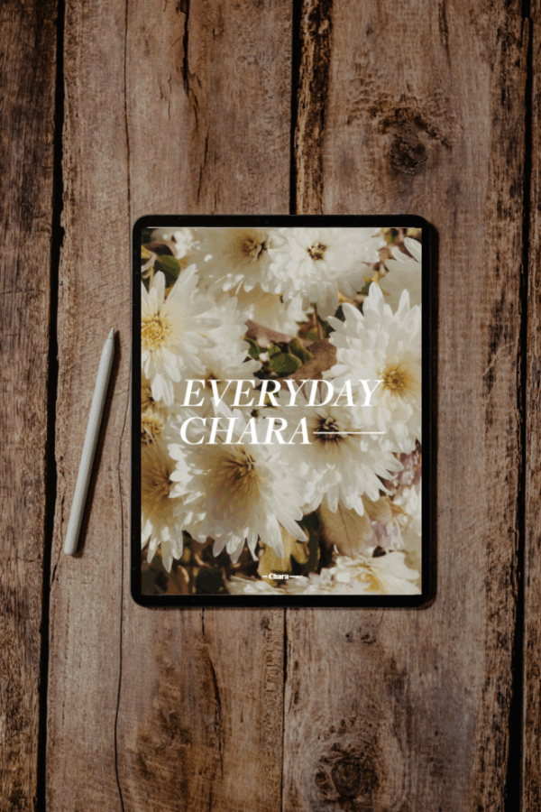 A tablet with a stylus on a wooden surface displays floral wallpaper and the words "EVERYDAY CHARA," making it an ideal companion for your 5-Week Everyday CHARA Bible Study (DIGITAL/PRINTABLE) sessions.